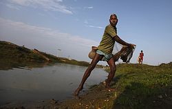 A fisherman casts his net on Feb. 19 in a river near Bahir Jonai, Assam, India. A vast and heavily populated region of Asia that depends on water from Tibetan rivers is feeling the effects of China's ambitious efforts to redraw its water map. Some even worry about future water wars, while others say there's still time for diplomacy to keep the peace.