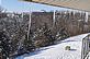 Icicles hang from a rooftop over looking the snow. Taken in early December in Dubuque by Beth Jenn.