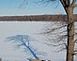 A tree casts a long shadow over the snow-covered Mississippi in Dubuque.		 