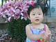 Alayna Kremer, 11 months old, daughter of Steve & Gail Kremer posing with Asian Lily. Taken July 2009 Cherokee, IA by Gail Kremer.