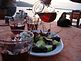 Octopus, homemade wine, and the port of Oia. Taken November 2008 Oia, Santorini, Greece by Ashley Blosch.