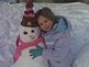 Skyla and her snowman. Taken January 14th Dubuque by Ashley Mahe.