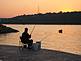 Man fishing at dusk on Mississippi River. Taken Summer 2008 along the river walk outside the Grand River Center by Sr. Lynn Winsor, BVM.