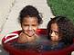 Cute pictures of my nieces in Canada in waterbucket outside their home.  I wanted to share with everyone how cute they are.